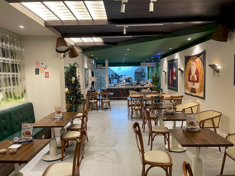 The restaurant features a modern interior with wooden furniture, evoking the charm of a traditional tea shop in the heart of the city 